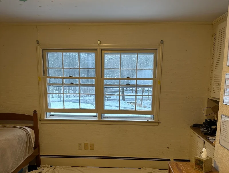 These double hung windows make the bedroom cold